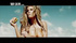 Blonde chick eats burger while sunbathing by the beach on tv commercial.