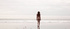 Beautiful mermaid in white bikini enjoys walking near the sea