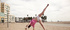 Tight teen in white shorts shows her acrobatic skills on the beach
