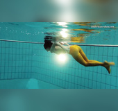 Naughty girl shows sexy feet swimming naked underwater