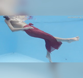 Girl in red dress filmed swimming around flashing nice pussy